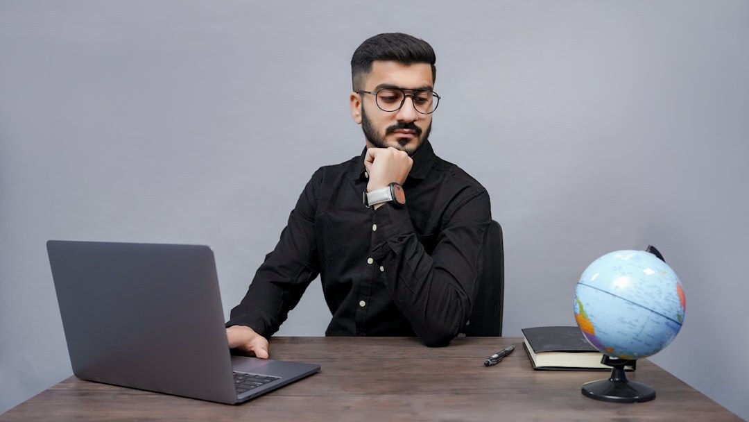 Young journalist working on a laptop writing news article