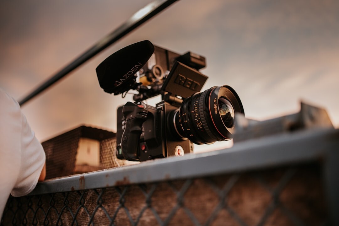 Camera operator filming with a professional video camera