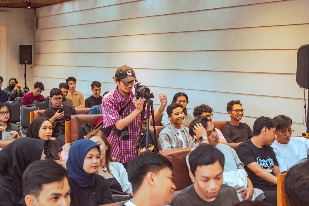 Group of journalism students in a media classroom with equipment