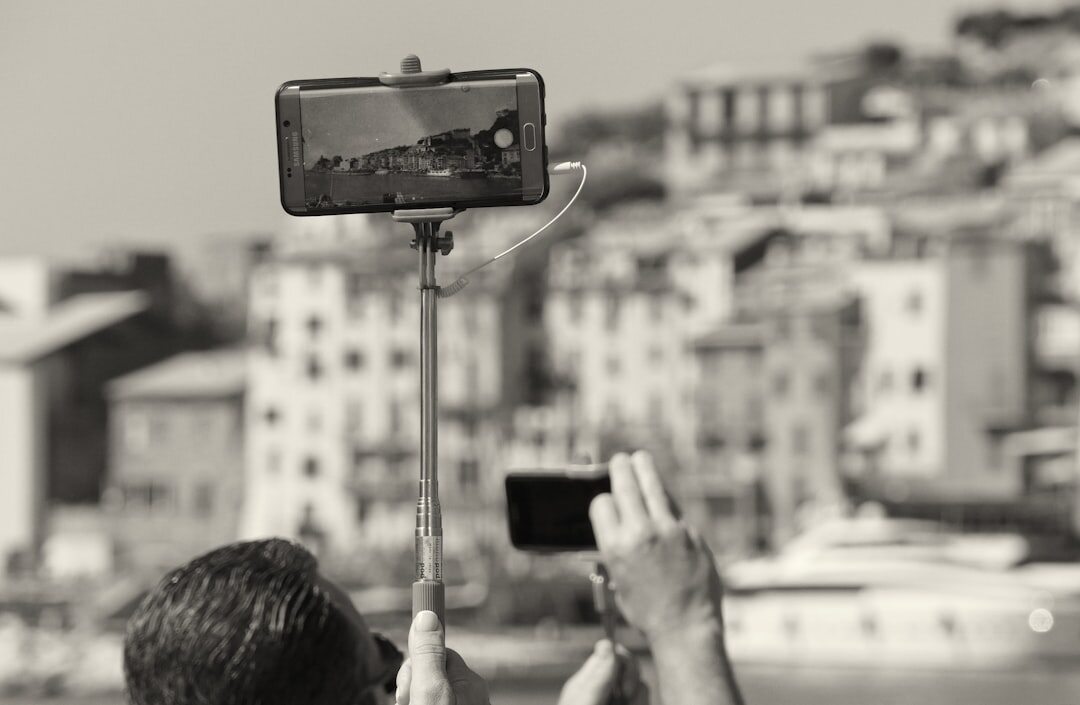 Reporter doing live mobile journalism with smartphone on a selfie stick